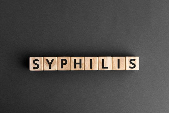 Syphilis - word from wooden blocks with letters, a disease caught during sexual activity syphilis concept, grey  background