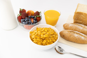 Healthy breakfast. bread, orange juice, strawberry, blueberries, milk and cereal in bowl on white background. Healthy food