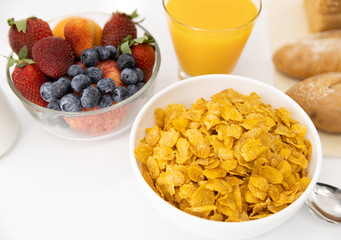Healthy breakfast. bread, orange juice, strawberry, blueberries, milk and cereal in bowl on white background. Healthy food