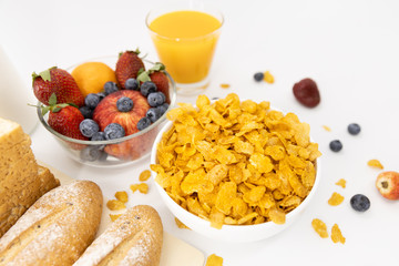 Healthy breakfast. bread, orange juice, strawberry, blueberries, milk and cereal in bowl on white background. Healthy food
