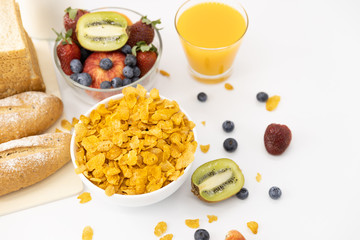 Healthy breakfast. bread, orange juice, strawberry, blueberries, kiwi, milk and cereal in bowl on white background. Healthy food