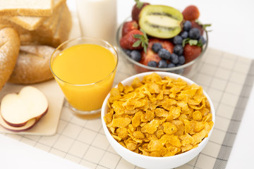 Healthy breakfast. bread, orange juice, strawberry, blueberries, kiwi, milk and cereal in bowl on mat background. Healthy food
