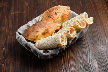 Pita bread of different types in a bread basket . restaurant menu