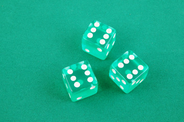 Three dices on green gaming table, gambling concept