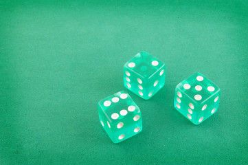 Three dices on green gaming table, gambling concept