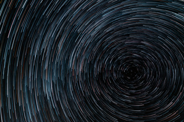Beautiful starry sky with star trails orientation on the north star. Space background.