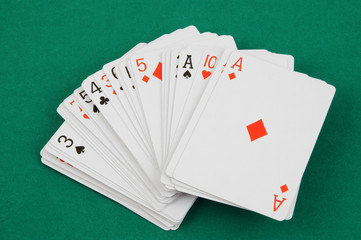 Playing cards on green table, gambling concept