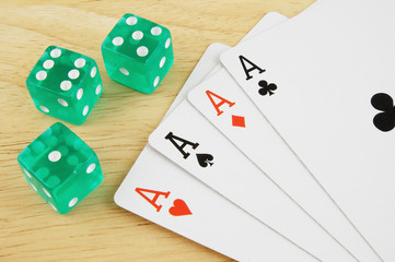 Dices and cards on wooden table, gambling concept