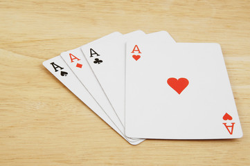 Aces on wooden table, gambling concept