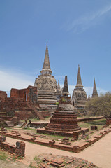 Fototapeta premium Asian religious architecture. Ancient pagoda at Wat Phra Sri Sanphet temple under blue sky. Ayutthaya, Thailand