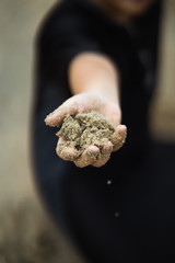 A hand full of sand
