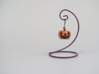 Jack O lantern hangs on purple hanger which made from wire bender. 