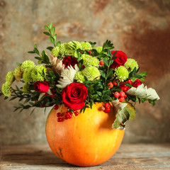 bouquet flowers in vase of pumpkin (roses, chrysanthemums, green branches, decoration), concept....