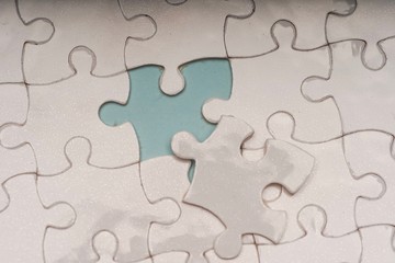 Closed up shot of blank white puzzle pieces, selective focus, copy space for text