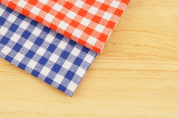 Red and blue tablecloth on wooden table
