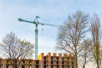 Construction of new house or building. General view. Unfinished cement building in the summer. The introduction of urbanization into nature. Capital construction in Ukraine