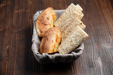 Pita bread of different types in a bread basket . restaurant menu