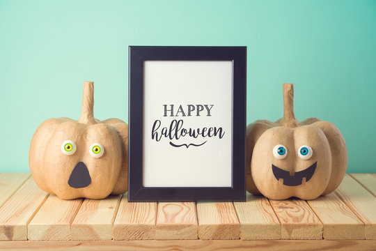 Halloween Holiday Concept With Cute Funny Pumpkin Decor And Photo Frame On Wooden Table