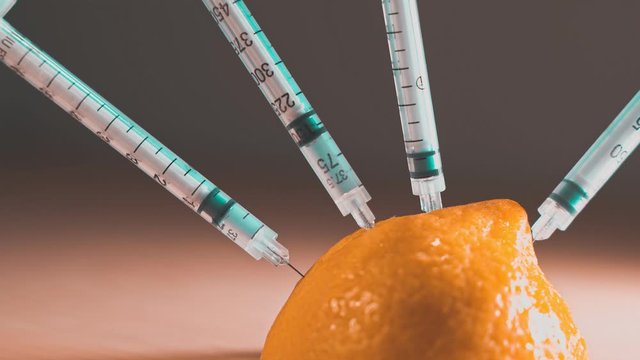 Extracting vitamin C from lemon. Suitable for concepts as Vitamins and flu vaccines for protection against swine flu or Genetically Modified organism. Teal and orange style.