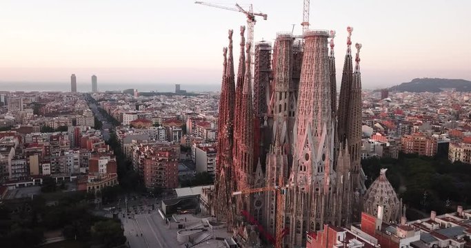 BARCELONA, SPAIN- JUNE 13, 2019: Aerial view of Sagrada Familia on background of Eixample district cityscape 