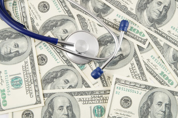 Stethoscope on dollar banknotes, cost of healthcare concept