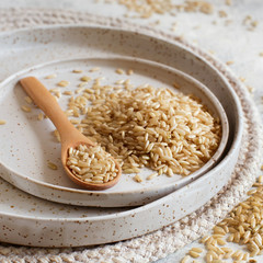 Brown rice on a plate with a  spoon