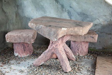 Tiny table and chairs in stone