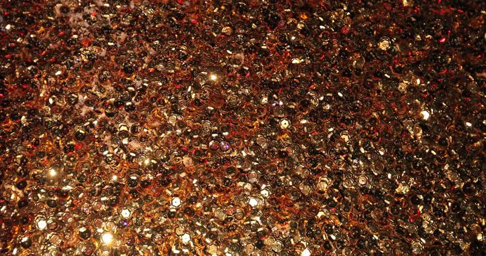 Golden shiny sequins spread over the surface. Flickering surface gives the feeling of christmas miracle.