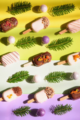 Ice cream and christmas decor on bright striped background.