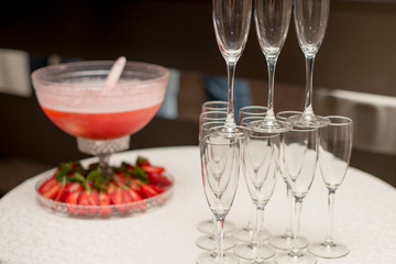 A pyramid of glasses. pink champagne with fruits.
