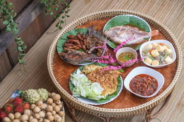 Set of Thai traditional food on a bamboo basket.