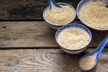 Quinoa in bowls on wooden table