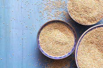 Quinoa in bowls on blue wooden table
