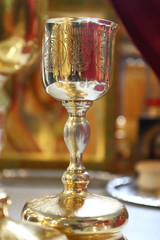 Orthodox churches. A silver cup for communion, a prosphora for the preparation of the sacred mystery of the Eucharist, and sweet wine on the table on the throne.