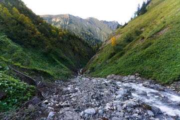 autumn landscape river with ice and snow and mountains in the back on the E5 path from oberstdorf to kemptner hut
