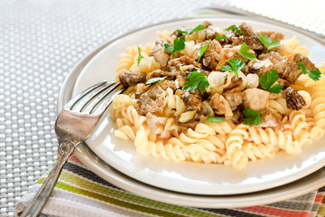 Spiral pasta with morel mushrooms on a plate