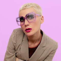 Blonde with short hair in fashionable glasses. Vintage style