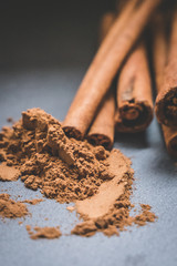 Cinnamon sticks and cinnamon powder on wood food photography