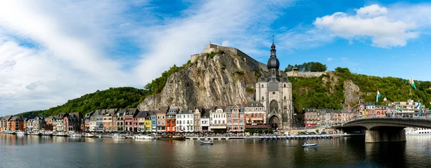 Fotobehang panorama view of the small town of Dinant on the Maas river with the historic citadel and cathedral on the river front © makasana photo