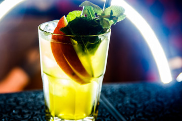 Glasses of cocktails on bar background