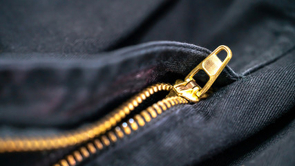 Close up Black jeans material and gold zipper