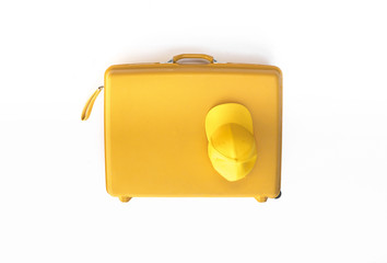Yellow suitcase with traveler accessories isolated on white background, travel concept, minimal style.
