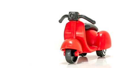 Isolated Red toy scooter on a white background.