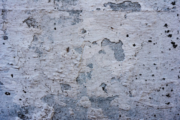 Texture of a concrete wall with cracks and scratches which can be used as a background