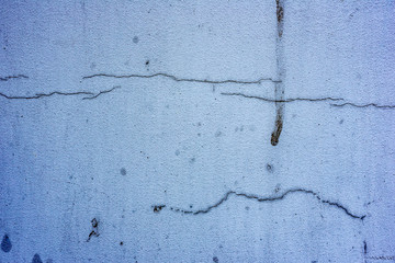 Texture of a concrete wall with cracks and scratches which can be used as a background