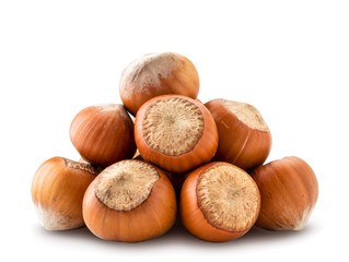A pile of hazelnuts close - up on a white. Isolated