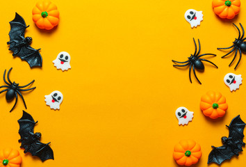 Naklejka na ściany i meble Halloween holiday concept, Pumpkin, bats, white skeleton and tiny ghost in orange background with copy space for text, Top flat view wallpaper