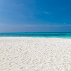 Fototapeta na wymiar Empty beach landscape seascape. Blue sky over white sand near tropical sea. Exotic island view, summer beach
