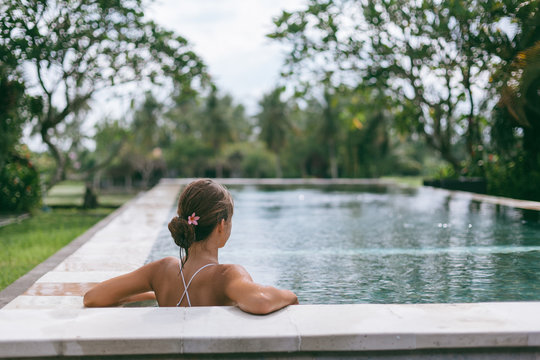 Infinity pool with a view on palm trees, Ubud, Bali