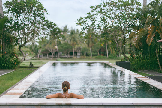 Infinity pool with a view on palm trees, Ubud, Bali